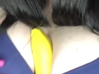 Young pussy sucks a banana and stuffs it between boobs