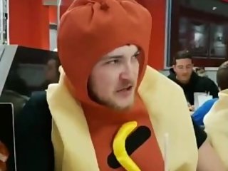 Man in hot dog costume is humiliated after man sexually eats hot dog.